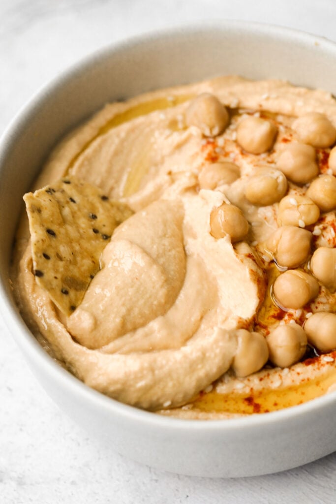 Whip up smooth and creamy classic hummus dip at home in just 5 minutes, by combining chickpeas, tahini, olive oil, lemon juice and garlic in the blender. | aheadofthyme.com