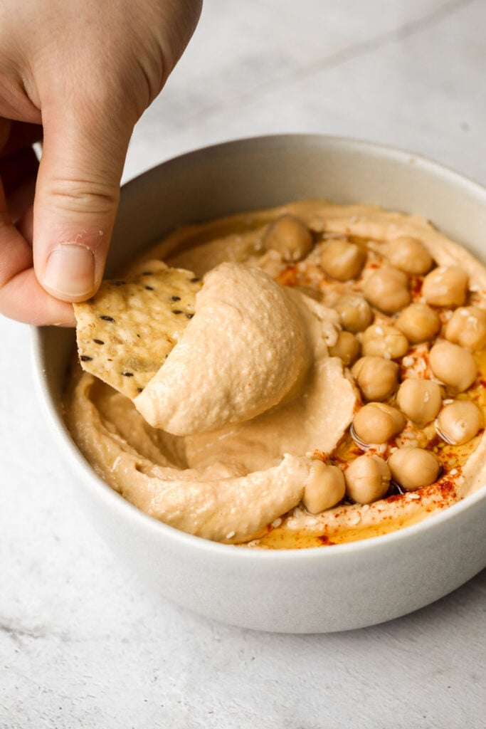 Whip up smooth and creamy classic hummus dip at home in just 5 minutes, by combining chickpeas, tahini, olive oil, lemon juice and garlic in the blender. | aheadofthyme.com