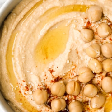 Whip up smooth and creamy classic hummus dip at home in just 5 minutes, by combining chickpeas, tahini, olive oil, lemon juice and garlic in the blender. | aheadofthyme.com