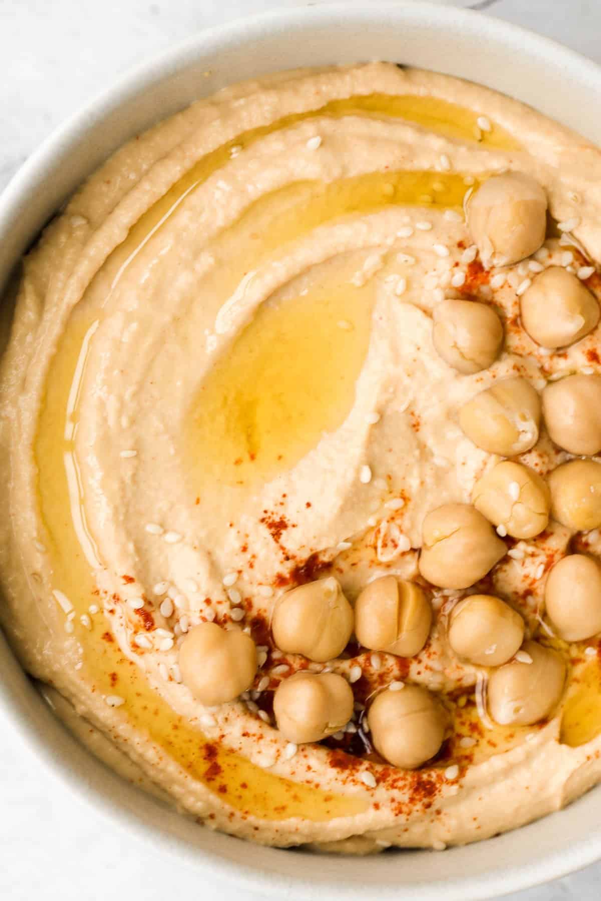 Whip up smooth and creamy classic hummus dip at home in just 5 minutes, by combining chickpeas, tahini, olive oil, lemon juice and garlic in the blender. | aheadofthyme.com