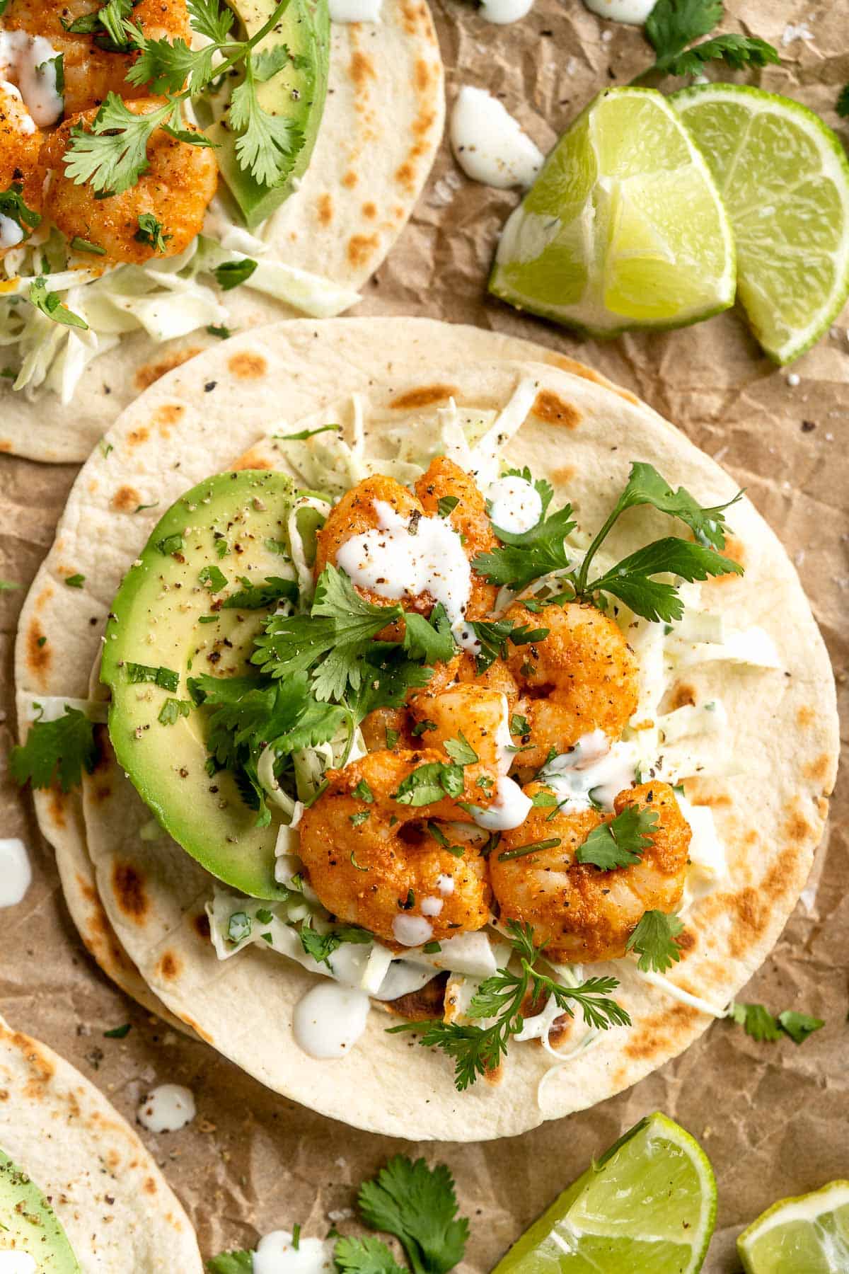 Quick and easy Shrimp Tacos with Lime Crema slaw are made with soft tortillas, seasoned shrimp, and creamy cabbage slaw — and ready in about 20 minutes! | aheadofthyme.com