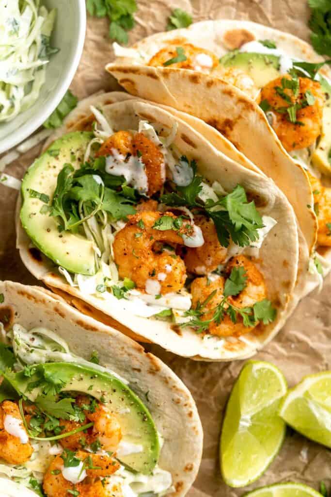 Quick and easy Shrimp Tacos with Lime Crema slaw are made with soft tortillas, seasoned shrimp, and creamy cabbage slaw — and ready in about 20 minutes! | aheadofthyme.com