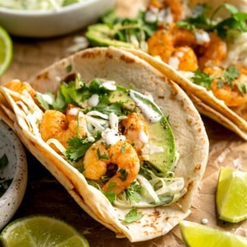 Quick and easy Shrimp Tacos with Lime Crema slaw are made with soft tortillas, seasoned shrimp, and creamy cabbage slaw — and ready in about 20 minutes! | aheadofthyme.com