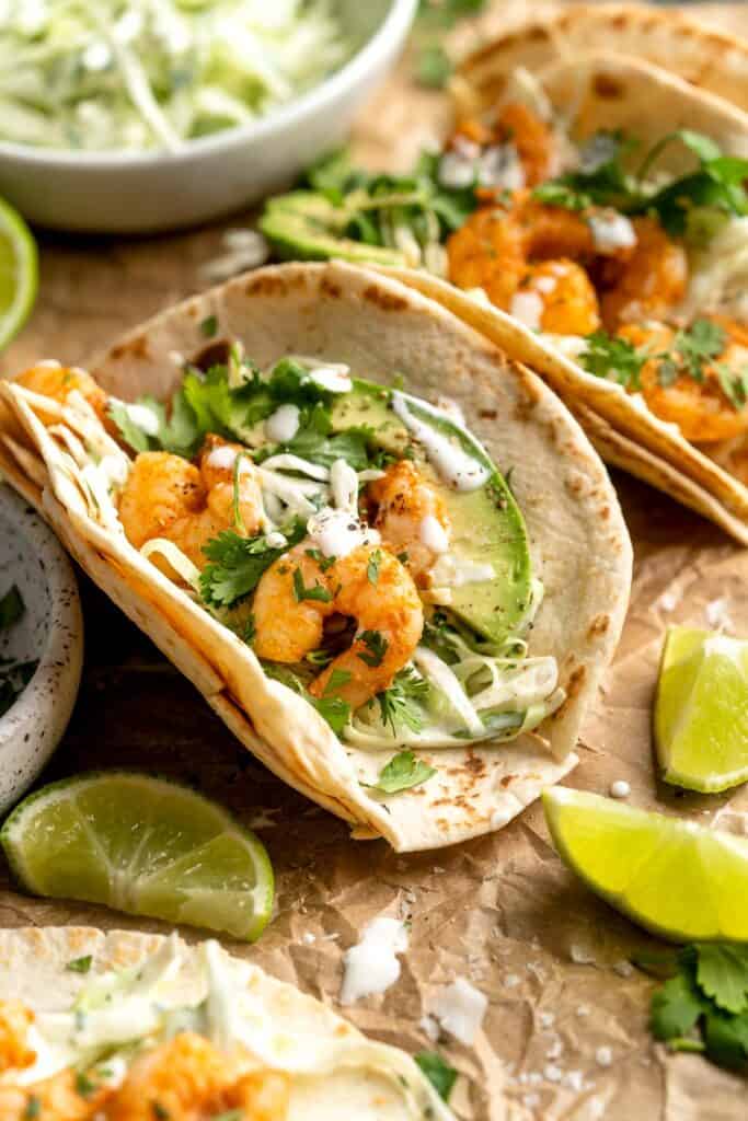 Quick and easy Shrimp Tacos with Lime Crema slaw are made with soft tortillas, seasoned shrimp, and creamy cabbage slaw — and ready in about 20 minutes! | aheadofthyme.com