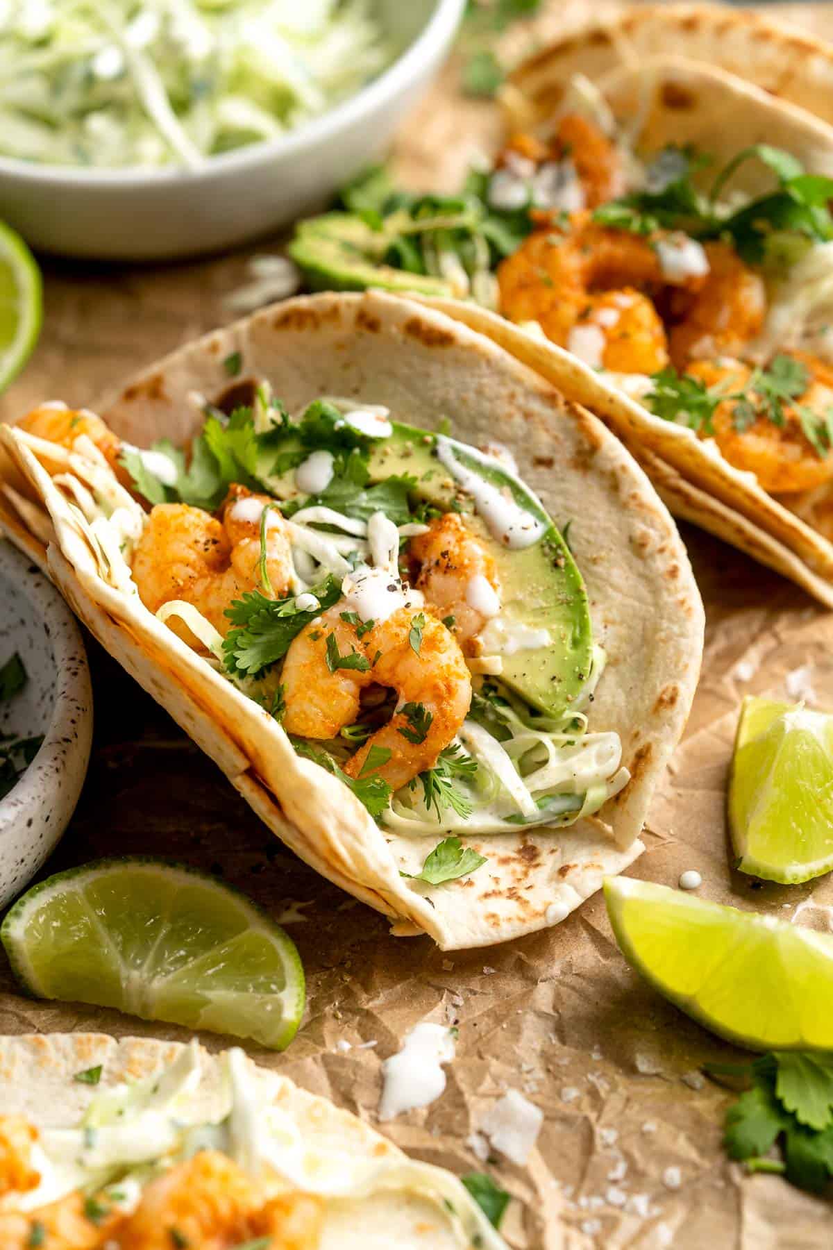 Quick and easy Shrimp Tacos with Lime Crema slaw are made with soft tortillas, seasoned shrimp, and creamy cabbage slaw — and ready in about 20 minutes! | aheadofthyme.com