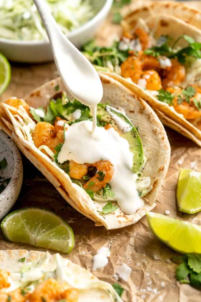 Quick and easy Shrimp Tacos with Lime Crema slaw are made with soft tortillas, seasoned shrimp, and creamy cabbage slaw — and ready in about 20 minutes! | aheadofthyme.com