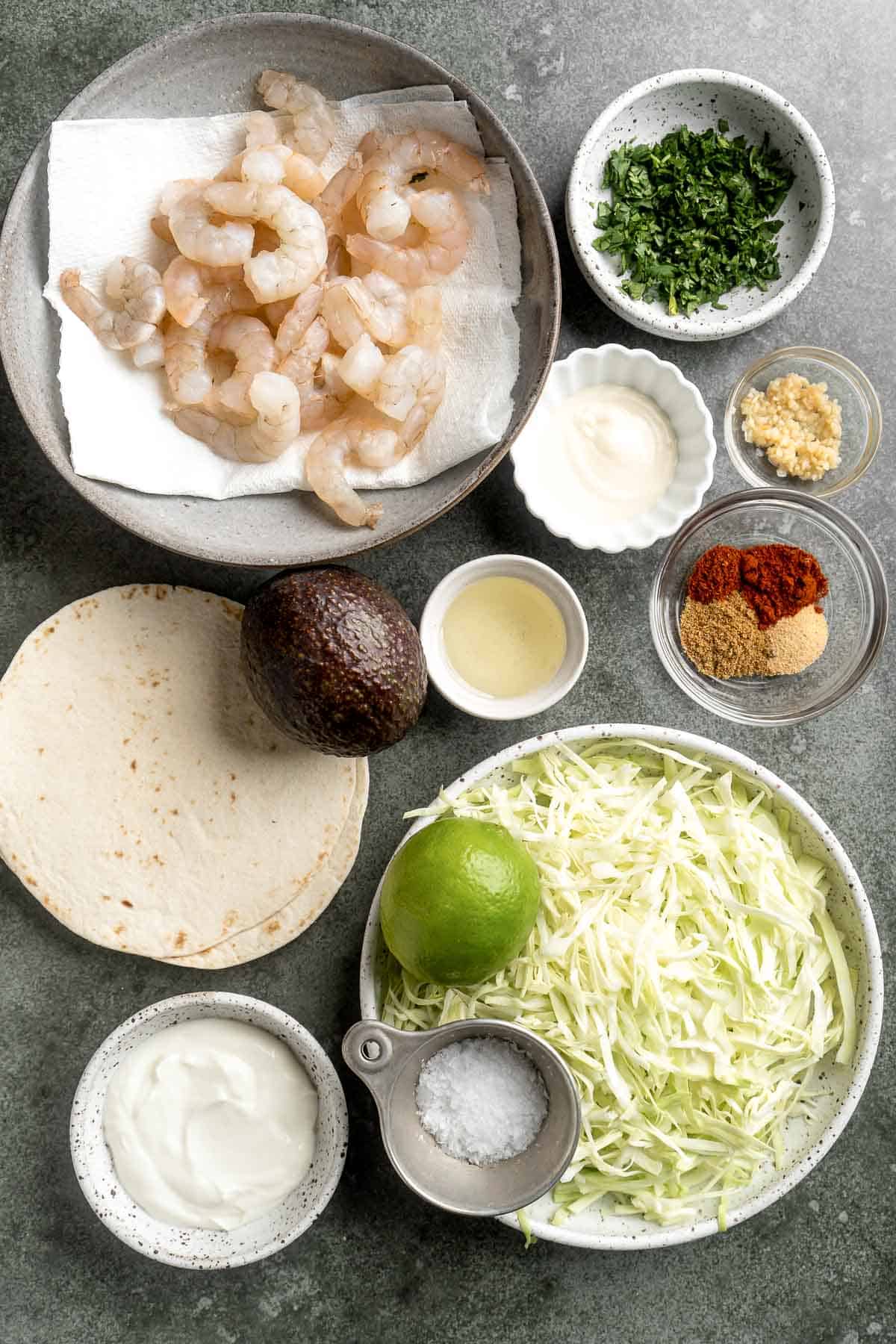 Quick and easy Shrimp Tacos with Lime Crema slaw are made with soft tortillas, seasoned shrimp, and creamy cabbage slaw — and ready in about 20 minutes! | aheadofthyme.com