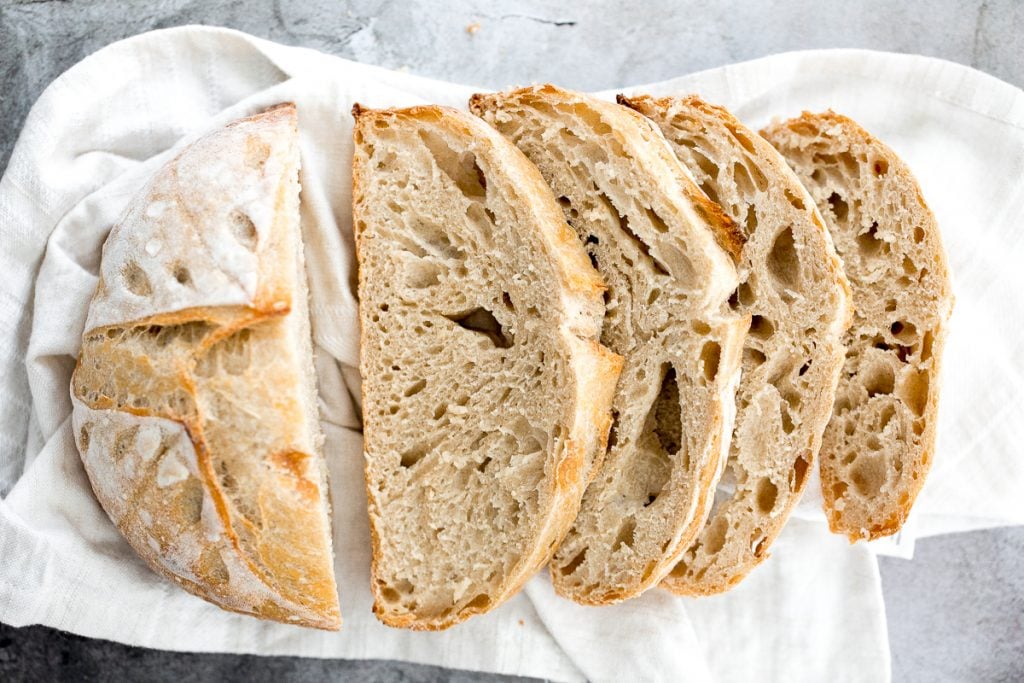 Small batch sourdough bread is airy and chewy with a crisp crust and a mild flavour. It takes less than 15 minutes of actual prep and requires no kneading. | aheadofthyme.com