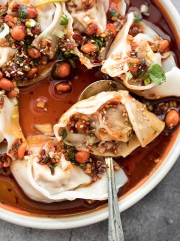 Easy spicy chili oil wontons, a signature Sichuan dish ready in just 10 minutes, hits every sense of your palate -- sour, spicy, sweet and nutty. | aheadofthyme.com