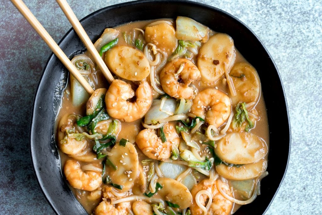 Better than takeout, stir-fried rice cakes with shrimp, bok choy, and bean sprouts in a delicious peanut butter sauce is a quick 10-minute one pan meal. | aheadofthyme.com