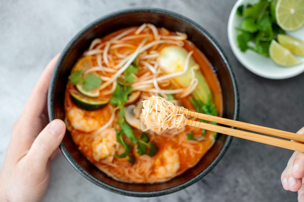 This gluten-free, one pot Thai red curry noodle soup is so flavourful and packed with shrimp, vermicelli rice noodles, fresh herbs, lime juice + fish sauce. | aheadofthyme.com