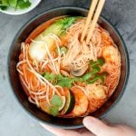 This gluten-free, one pot Thai red curry noodle soup is so flavourful and packed with shrimp, vermicelli rice noodles, fresh herbs, lime juice + fish sauce. | aheadofthyme.com