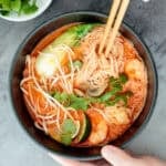 This gluten-free, one pot Thai red curry noodle soup is so flavourful and packed with shrimp, vermicelli rice noodles, fresh herbs, lime juice + fish sauce. | aheadofthyme.com