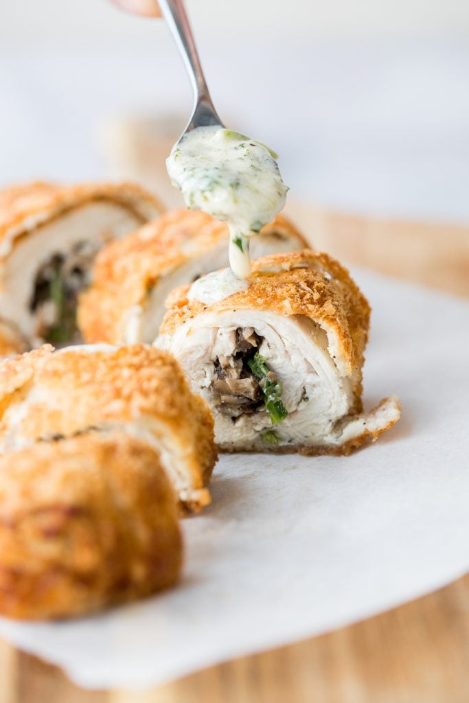 Give your chicken breasts an upgrade by stuffing them to make fancy, juicy chicken roulade with spinach and mushrooms topped with a creamy alfredo sauce. | aheadofthyme.com