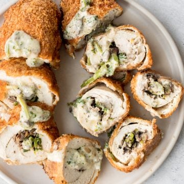 Give your chicken breasts an upgrade by stuffing them to make fancy, juicy chicken roulade with spinach and mushrooms topped with a creamy alfredo sauce. | aheadofthyme.com