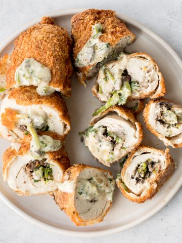Give your chicken breasts an upgrade by stuffing them to make fancy, juicy chicken roulade with spinach and mushrooms topped with a creamy alfredo sauce. | aheadofthyme.com
