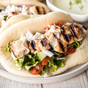 This refreshing and light, easy Greek chicken gyros is packed with tender souvlaki chicken, Greek salad, and homemade tzatziki sauce, all wrapped in a pita. | aheadofthyme.com