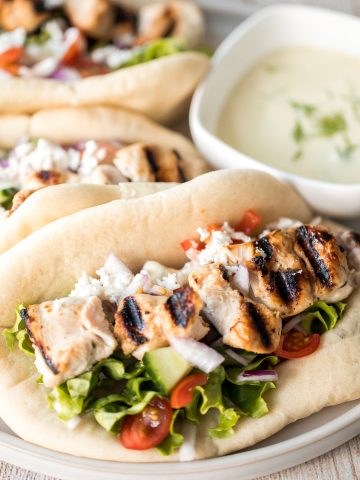 This refreshing and light, easy Greek chicken gyros is packed with tender souvlaki chicken, Greek salad, and homemade tzatziki sauce, all wrapped in a pita. | aheadofthyme.com
