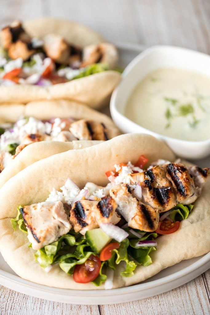 This refreshing and light, easy Greek chicken gyros is packed with tender souvlaki chicken, Greek salad, and homemade tzatziki sauce, all wrapped in a pita. | aheadofthyme.com