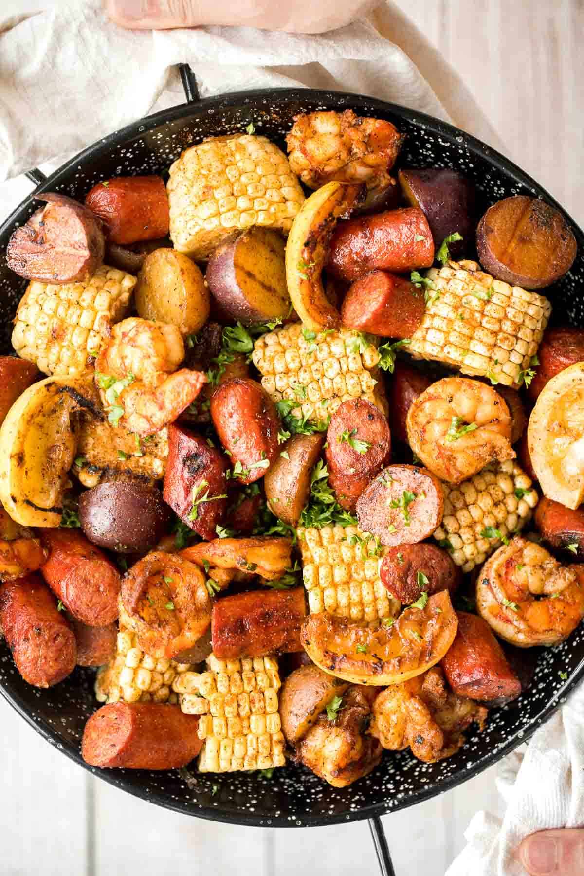 Easy Grilled Shrimp Boil is the ultimate summer meal: loaded with prawns, corn, and sausage, tossed in buttery garlic and herbs. Ready in 30 minutes! | aheadofthyme.com