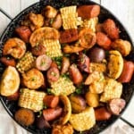 Easy Grilled Shrimp Boil is the ultimate summer meal: loaded with prawns, corn, and sausage, tossed in buttery garlic and herbs. Ready in 30 minutes! | aheadofthyme.com