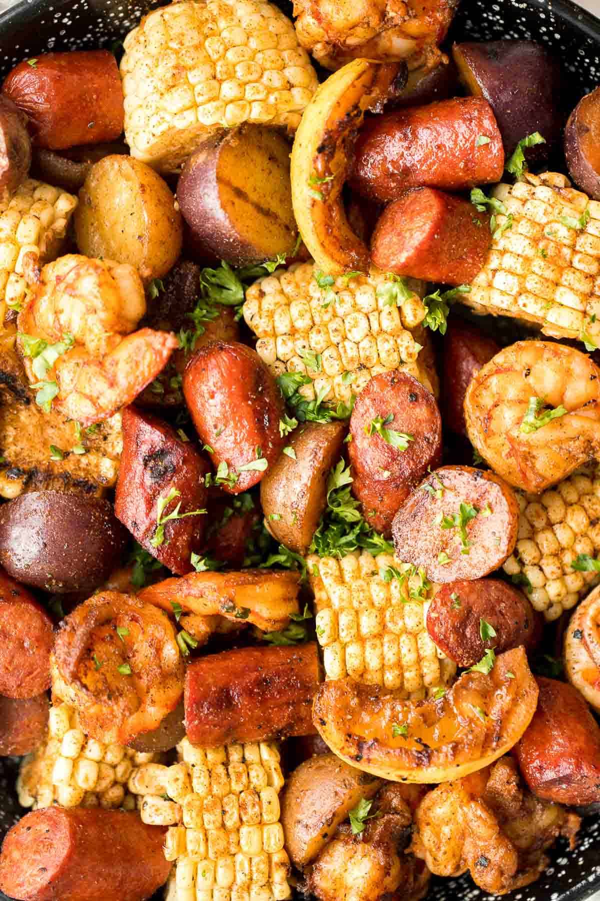Easy Grilled Shrimp Boil is the ultimate summer meal: loaded with prawns, corn, and sausage, tossed in buttery garlic and herbs. Ready in 30 minutes! | aheadofthyme.com