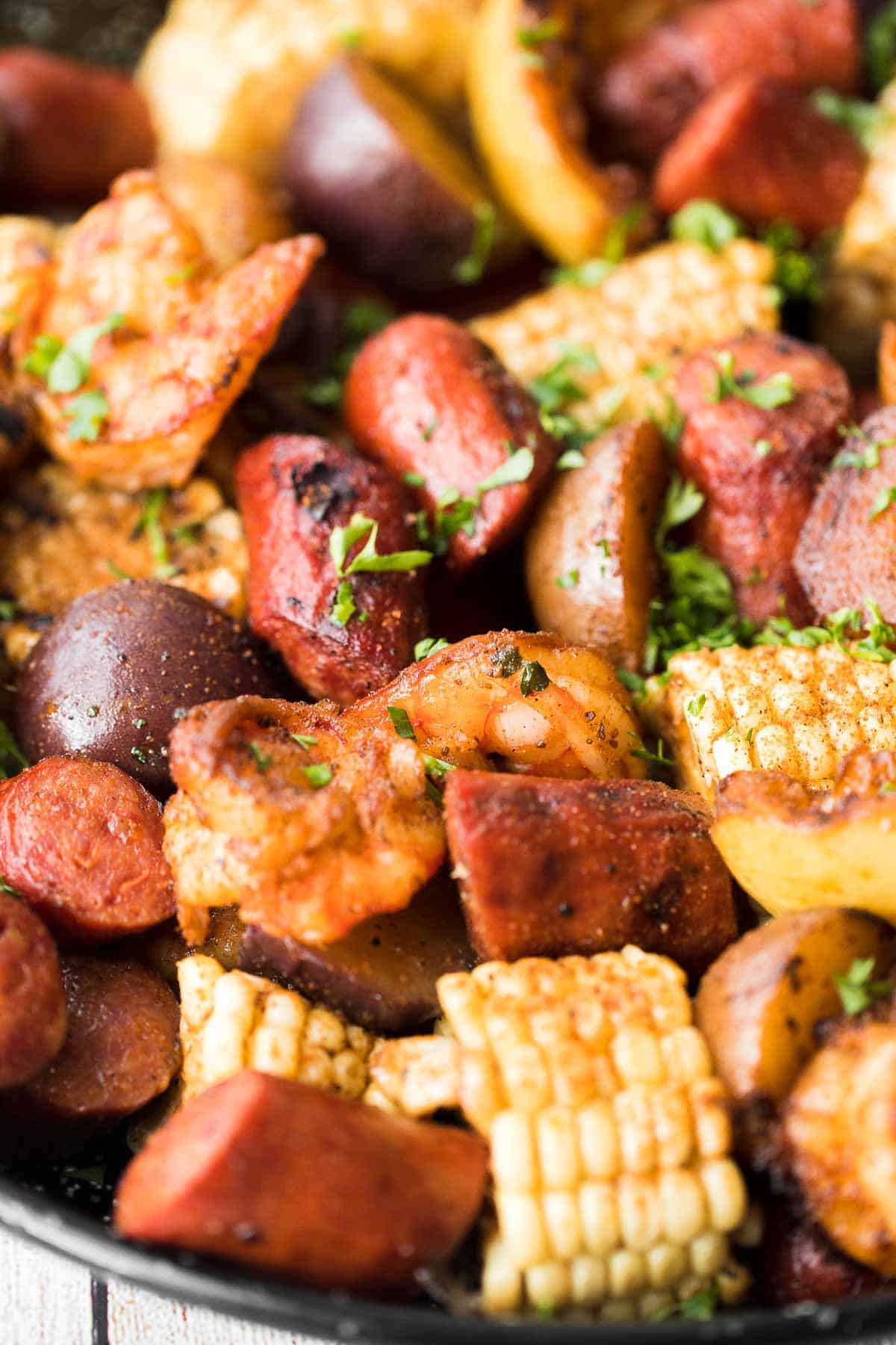Easy Grilled Shrimp Boil is the ultimate summer meal: loaded with prawns, corn, and sausage, tossed in buttery garlic and herbs. Ready in 30 minutes! | aheadofthyme.com