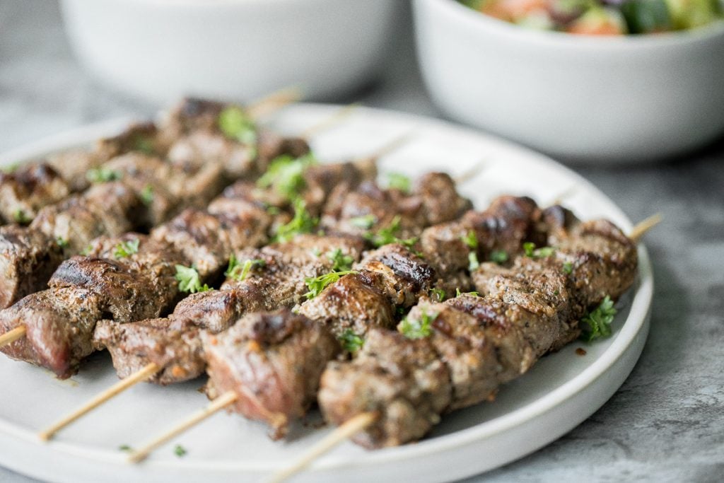 Quick and easy, grilled Greek lamb souvlaki skewers are marinated in a simple Mediterranean marinade for just 30 minutes. Serve with some tzatziki sauce. | aheadofthyme.com