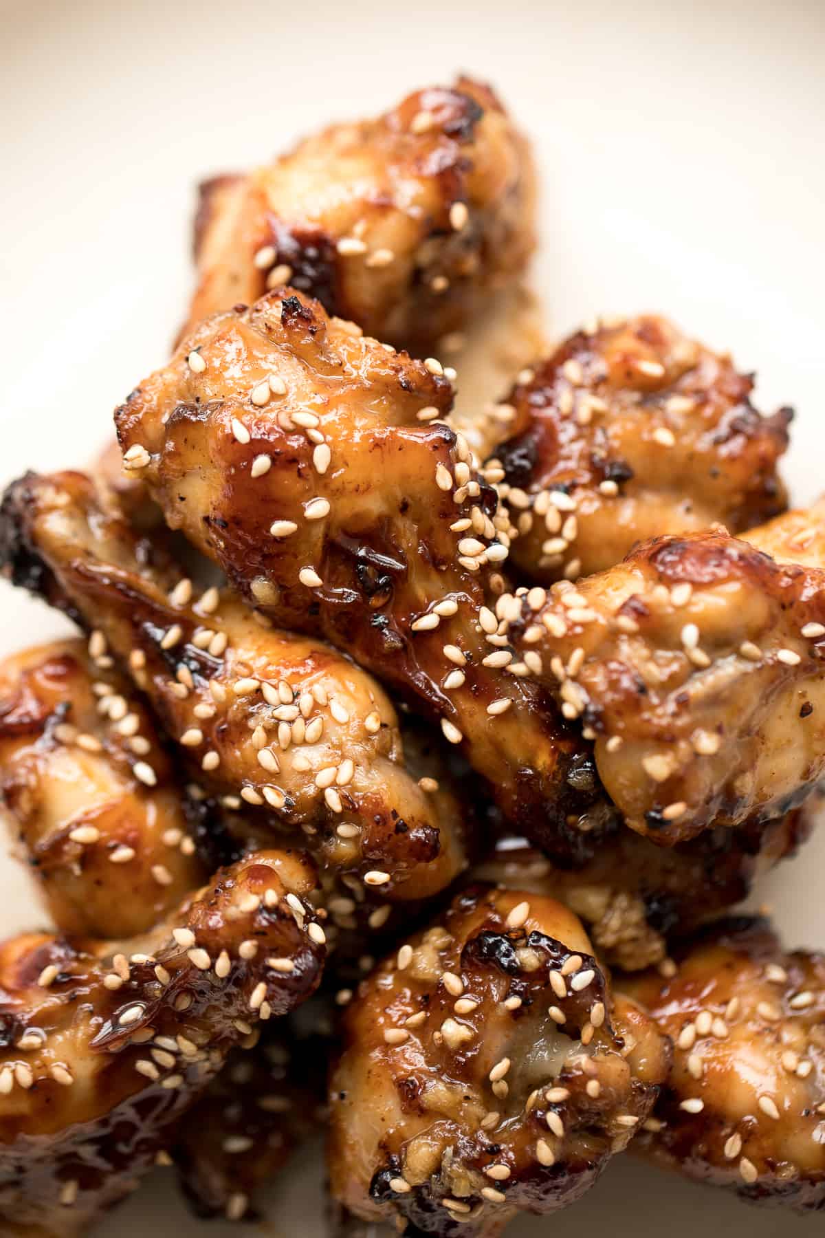These sweet and sticky honey garlic chicken wings are baked or air fried until crispy and tossed in a honey garlic sauce. So addictive and so easy to make. | aheadofthyme.com
