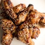 These sweet and sticky honey garlic chicken wings are baked or air fried until crispy and tossed in a honey garlic sauce. So addictive and so easy to make. | aheadofthyme.com