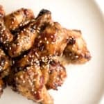 These sweet and sticky honey garlic chicken wings are baked or air fried until crispy and tossed in a honey garlic sauce. So addictive and so easy to make. | aheadofthyme.com