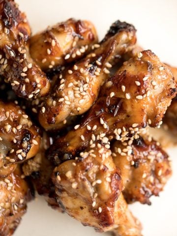 These sweet and sticky honey garlic chicken wings are baked or air fried until crispy and tossed in a honey garlic sauce. So addictive and so easy to make. | aheadofthyme.com