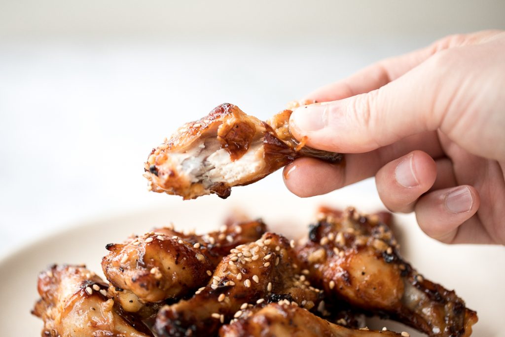 These sweet and sticky honey garlic chicken wings are baked or air fried until crispy and tossed in a honey garlic sauce. So addictive and so easy to make. | aheadofthyme.com