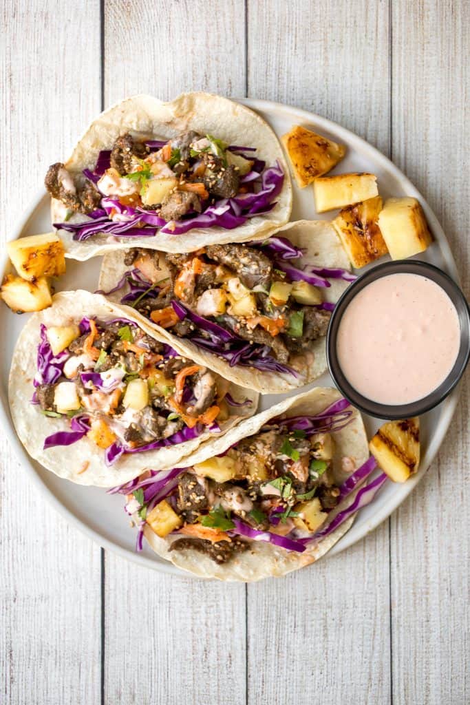 Fusion-style Korean beef steak tacos are made with tender, flavour-packed slices of beef and topped with caramelized pineapple, kimchi, and spicy mayo. | aheadofthyme.com