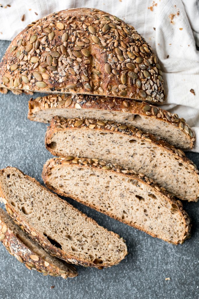 Small batch multi-seeded whole wheat sourdough bread is airy and chewy, is loaded with seeds inside, and has a signature crispy crust coated in more seeds. | aheadofthyme.com