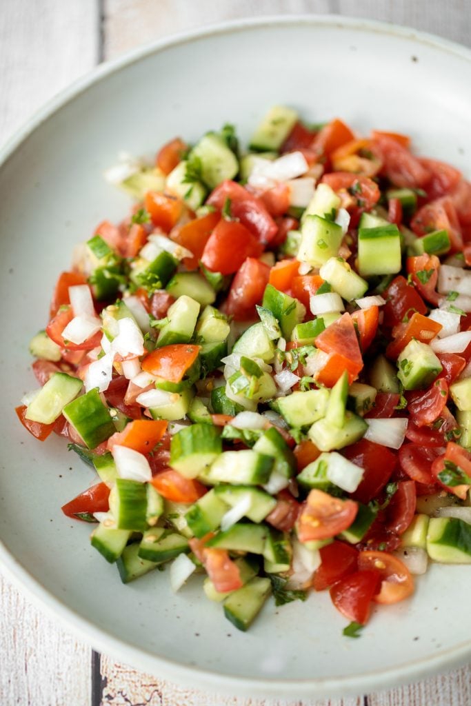 Healthy, light and refreshing Persian Shirazi salad with cucumber and tomato is a simple salad packed with herbs and tossed in an olive oil and lime dressing. | aheadofthyme.com