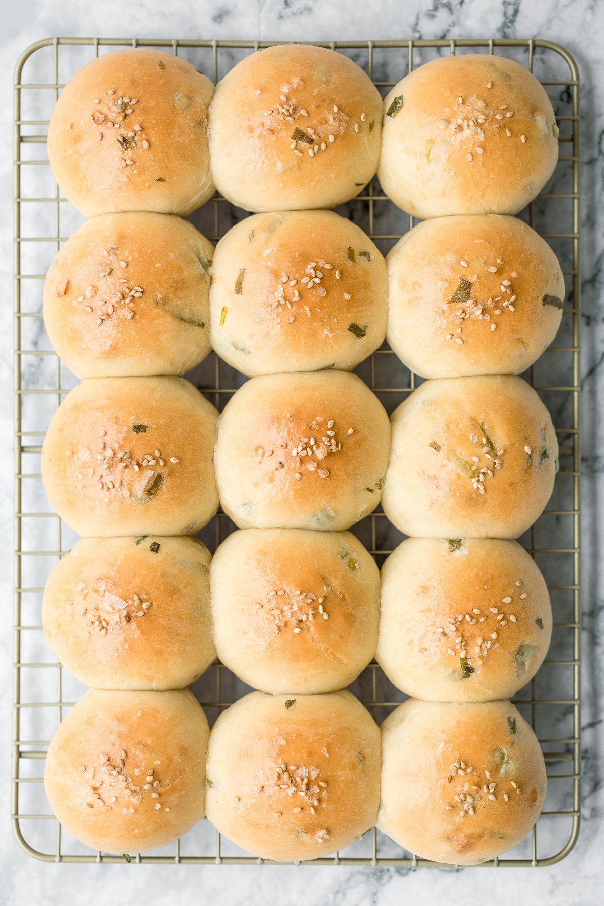 Soft and fluffy, quick dinner bread rolls are loaded with green onions and topped with flaked sea salt and sesame seeds. Ready in just 1.5 hours. | aheadofthyme.com