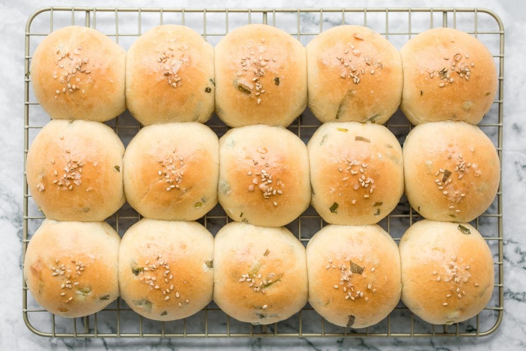 Soft and fluffy, quick dinner bread rolls are loaded with green onions and topped with flaked sea salt and sesame seeds. Ready in just 1.5 hours. | aheadofthyme.com