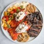 Fancy, restaurant-quality surf and turf is super easy to make with fresh lobster tail and tender rib-eye steak with a delicious garlic butter sauce. | aheadofthyme.com