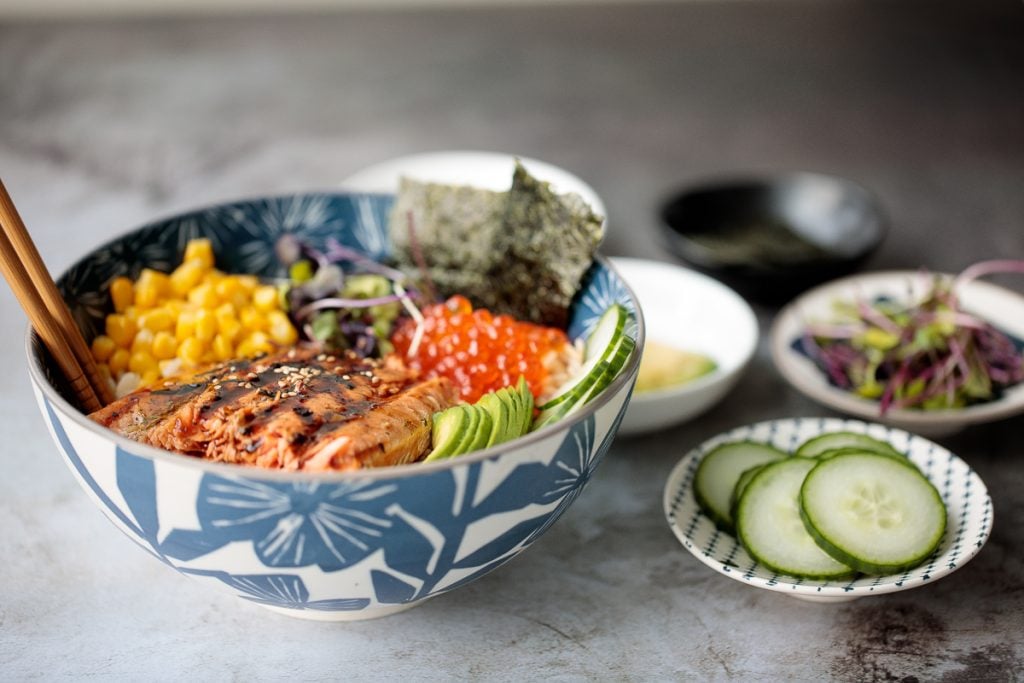 Easy to make, light and fresh teriyaki grilled salmon rice bowl is topped with vegetables, seaweed and salmon roe, with homemade teriyaki sauce on top. | aheadofthyme.com