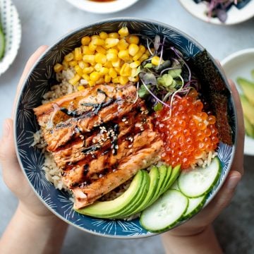 Easy to make, light and fresh teriyaki grilled salmon rice bowl is topped with vegetables, seaweed and salmon roe, with homemade teriyaki sauce on top. | aheadofthyme.com