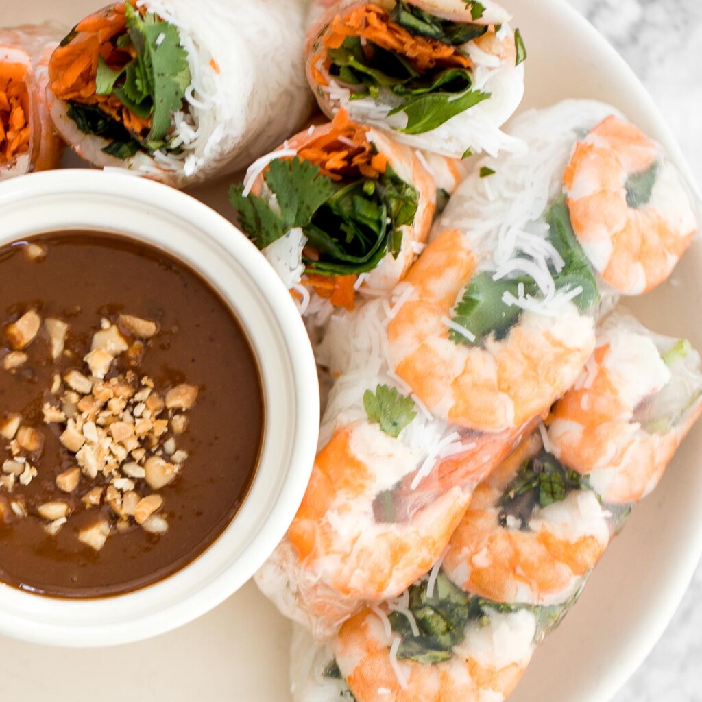 Fresh, light, and healthy Vietnamese Salad Rolls are filled with shrimp, vegetables, and herbs, and served with a delicious homemade peanut dipping sauce. | aheadofthyme.com