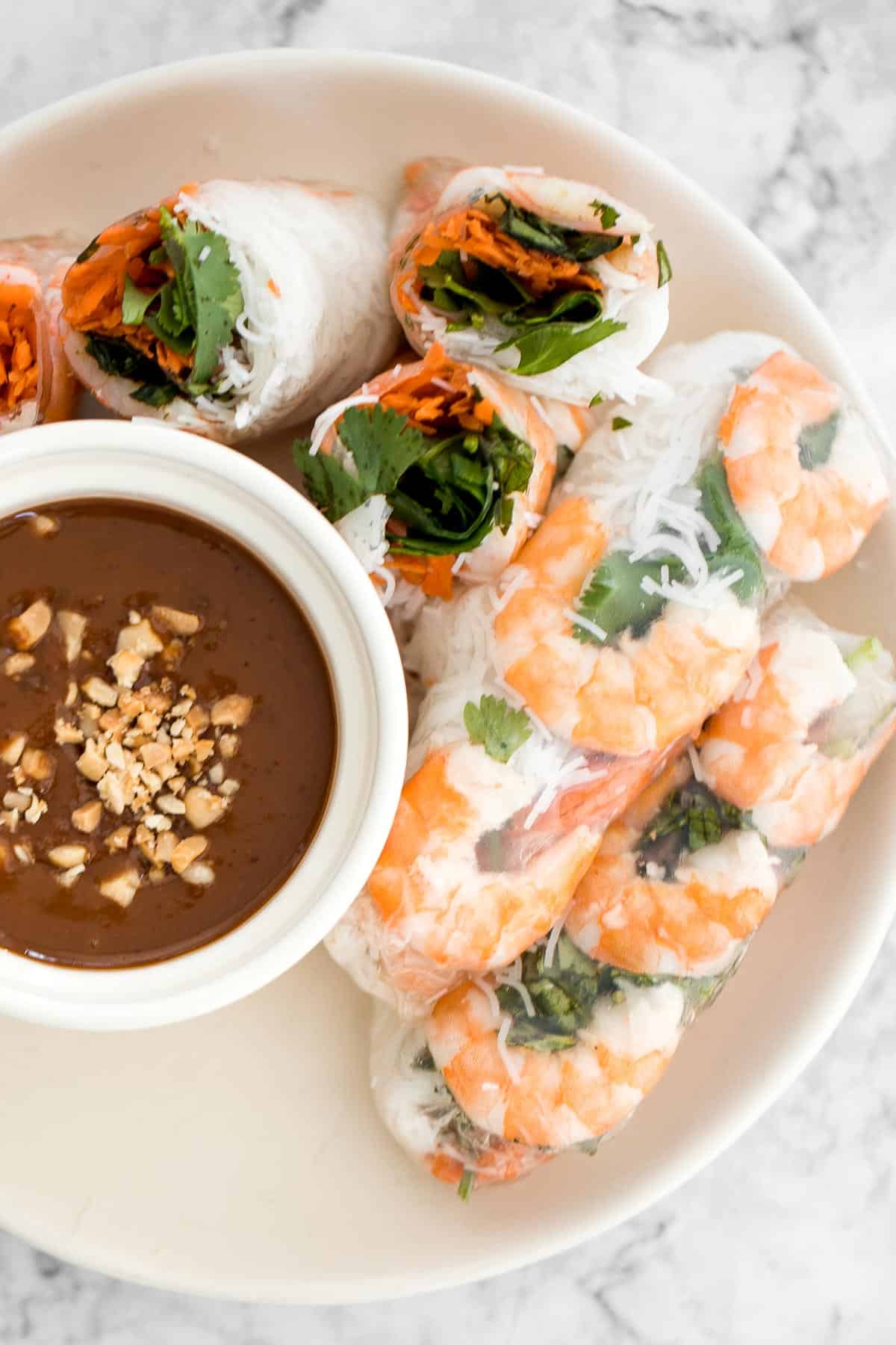 Fresh, light, and healthy Vietnamese Salad Rolls are filled with shrimp, vegetables, and herbs, and served with a delicious homemade peanut dipping sauce. | aheadofthyme.com