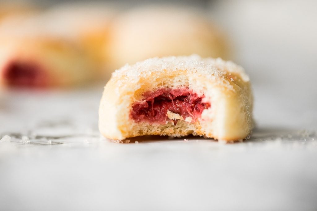 These melt-in-your-mouth, homemade baked jelly donuts, coated in sugar and filled with sweet strawberry jam, are so soft, fluffy, spongy and airy. | aheadofthyme.com