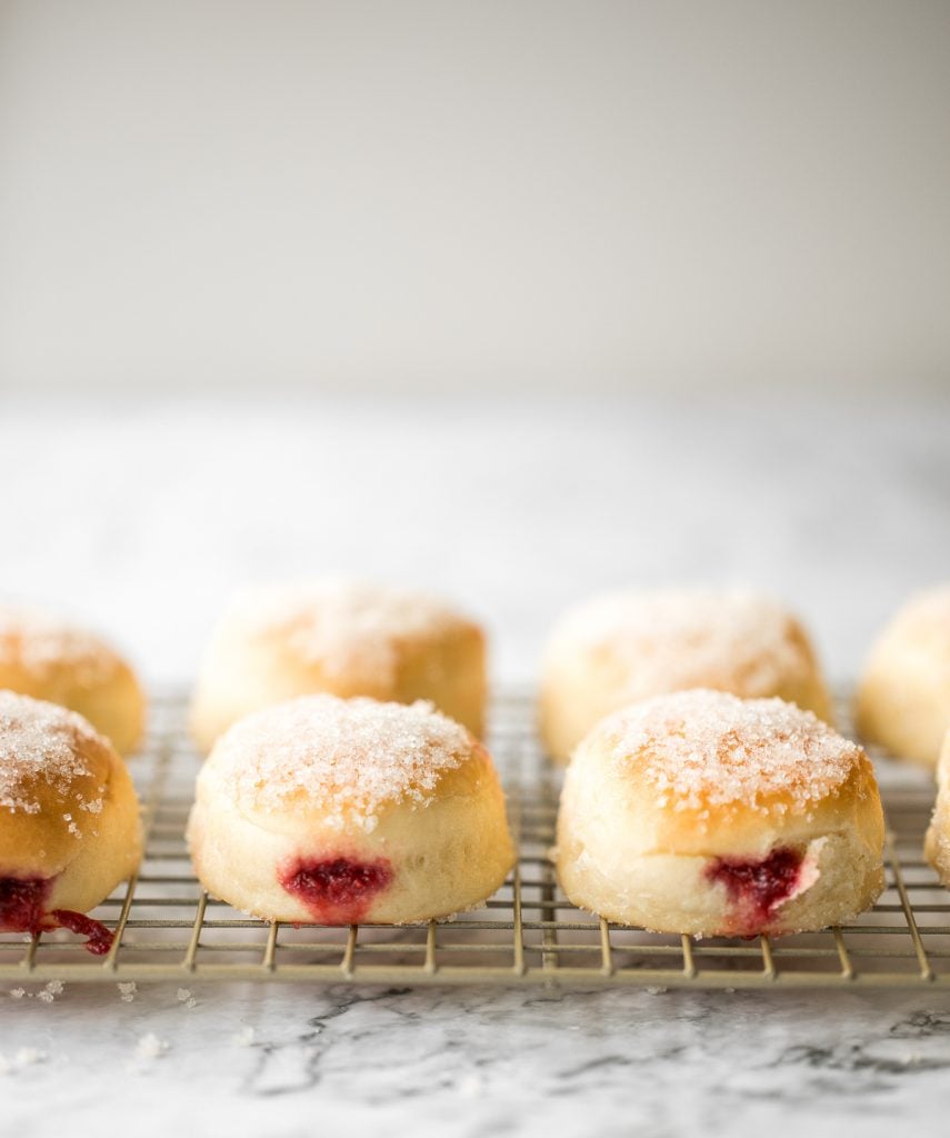 These melt-in-your-mouth, homemade baked jelly donuts, coated in sugar and filled with sweet strawberry jam, are so soft, fluffy, spongy and airy. | aheadofthyme.com