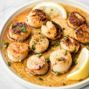 Garlicky, buttery, and perfectly seared scallops take less than 10 minutes to prep and cook. It's the easiest fancy, restaurant-grade meal to make at home. | aheadofthyme.com