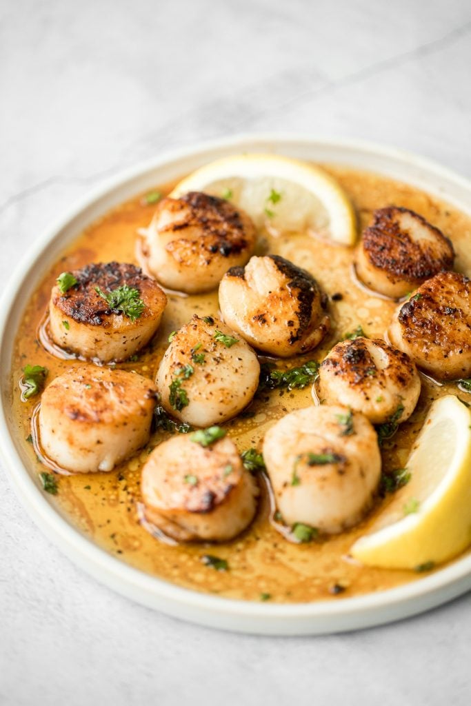 Garlicky, buttery, and perfectly seared scallops take less than 10 minutes to prep and cook. It's the easiest fancy, restaurant-grade meal to make at home. | aheadofthyme.com