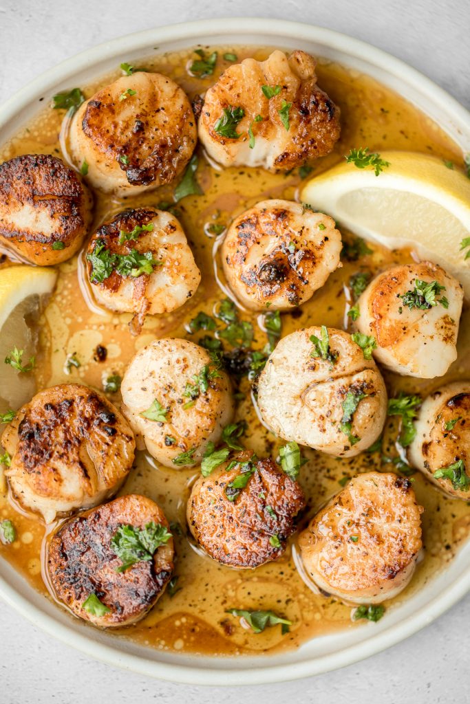 Garlicky, buttery, and perfectly seared scallops take less than 10 minutes to prep and cook. It's the easiest fancy, restaurant-grade meal to make at home. | aheadofthyme.com