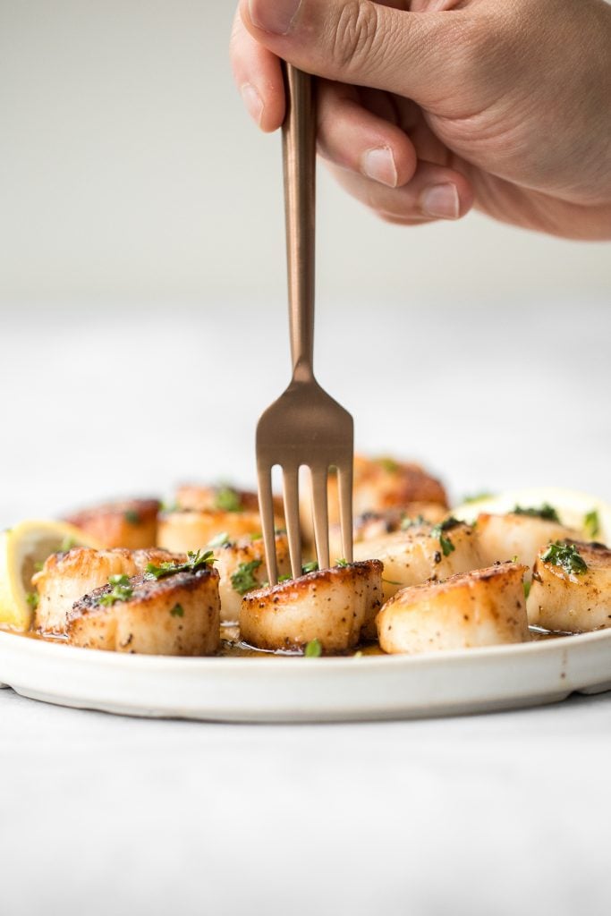 Garlicky, buttery, and perfectly seared scallops take less than 10 minutes to prep and cook. It's the easiest fancy, restaurant-grade meal to make at home. | aheadofthyme.com