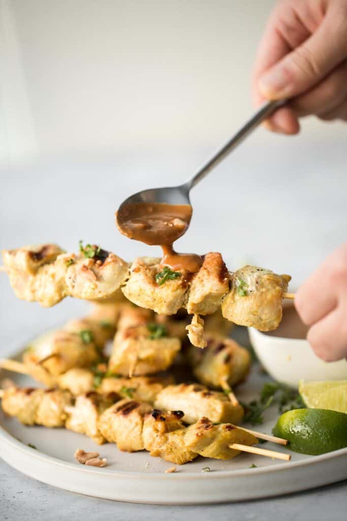 Better than takeout, these Chicken Satay Skewers with a peanut sauce are juicy, tender, and easy to make at home. They're savoury, sweet, tangy, and nutty. | aheadofthyme.com